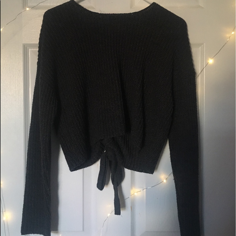 Gray sweater with lace up design on back.